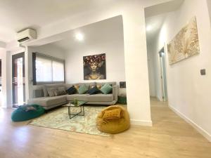 a white living room with a couch and a table at Barcelona New Apartment- Free Parking- 10 min by metro from BCN Center and Sagrada Família in Barcelona