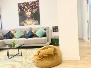 a living room with a couch and a table at Barcelona New Apartment- Free Parking- 10 min by metro from BCN Center and Sagrada Família in Barcelona