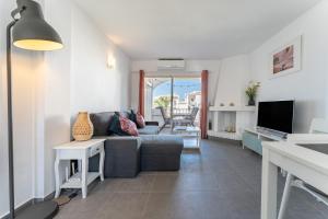 a living room with a couch and a tv at 210 Mijas Sea View Bahia Playa in La Cala de Mijas