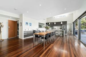 a kitchen and dining room with a wooden table and chairs at Azure in Wye River