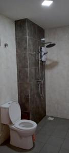 a bathroom with a toilet and a shower at Melangok Homestay in Kajang