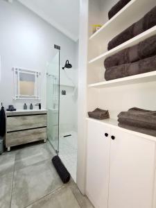 a bathroom with a glass shower and a sink at Victoria's Secret in Kenton on Sea