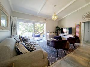 a living room with a couch and a table at Victoria's Place in Kenton on Sea
