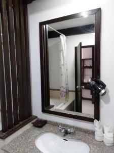 a bathroom with a sink and a mirror at Grand Phranakhon Hotel in Phra Nakhon Si Ayutthaya