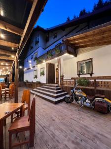 a motorcycle parked on a deck in front of a building at Barlogul din Vidraru in Curtea de Argeş