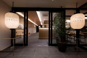 a lobby with two large lights and a table at Hotel KAN-RAKU Akita Kawabata in Akita