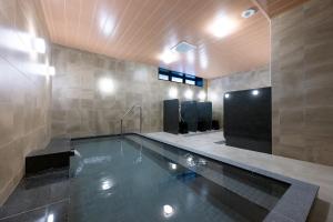 a swimming pool in a room with at Hotel KAN-RAKU Akita Kawabata in Akita