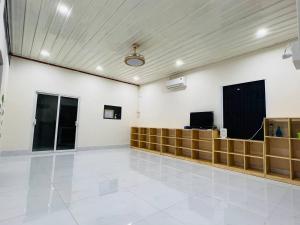 a large empty room with a television on a wall at Charis Home- Tay Ninh in Tây Ninh