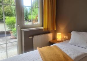 a bedroom with a bed and a window at Villa Florl in Schladming