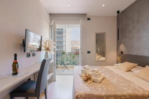 a dining room with a table and a desk and a table and chair at Welcome Cagliari in Cagliari +95 photos