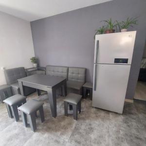 a room with a table and a refrigerator and chairs at Hostel Divan in Yerevan