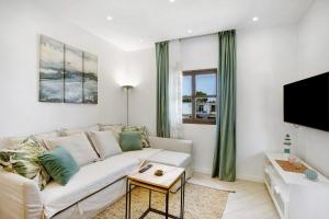 a living room with a couch and a tv at El Drago in Costa Del Silencio