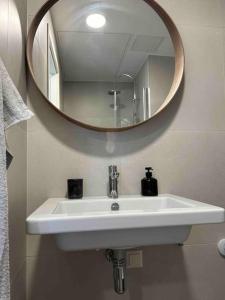 a bathroom sink with a large mirror above it at Haki Apartment in Tartu