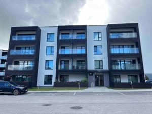 a building with a car parked in front of it at Haki Apartment in Tartu