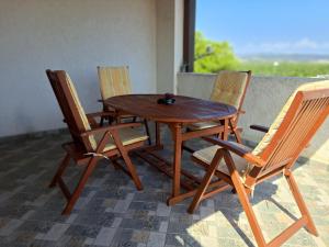 a wooden table and four chairs sitting around a table at Apartman Šuperba A1 in Šibenik