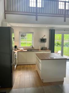 a kitchen with white cabinets and a counter top at Ferienhaus Fichtenhütte in Finnentrop