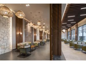 a waiting room with tables and chairs and chandeliers at Swandor Hotels & Resorts - Kemer in Kemer