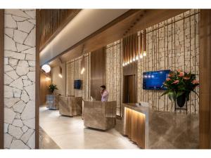 a lobby with a row of desks and a person at Swandor Hotels & Resorts - Kemer in Kemer