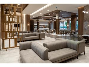 a lobby with couches and tables and a restaurant at Swandor Hotels & Resorts - Kemer in Kemer