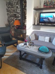 a living room with a couch and a table at Les MIRABELLES chambres d'hôtes in Sisteron