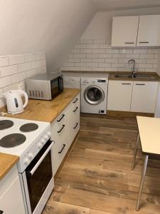 a kitchen with white cabinets and a stove top oven at Monteurwohnungen Visselhövede in Visselhövede