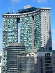 dois arranha-céus altos numa cidade com edifícios em KLCC Skysuites with Private Balcony and Terrace em Kuala Lumpur
