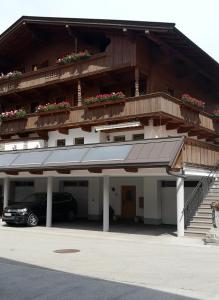 a building with a car parked in a parking lot at Chalet Innertal in Inneralpbach