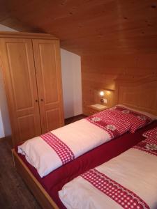 a bedroom with two beds in a cabin at Chalet Innertal in Inneralpbach