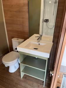 a bathroom with a sink and a toilet at UCPA Eco Lodge in Séné