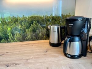 a coffee maker sitting on a table next to a window at Ferienhaus Fichtenhütte in Finnentrop