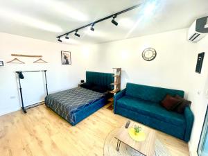 a living room with a couch and a table at Central Studio Apartment 1, Tirana in Tirana