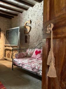 a room with a couch with a letter s on the wall at Ca' Maranghi Holiday House in Palazzuolo sul Senio