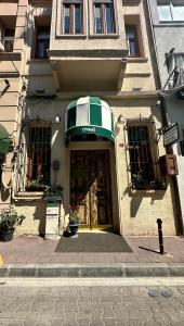 a building with an entrance to a store with a green awning at Tom Square Boutique Hotel in Istanbul
