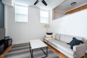 a living room with a couch and a table at Dupont Circle 1BR nr U St Metro Glens Mkt WDC-179 in Washington, D.C.