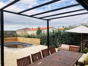 a patio with a table and chairs and a pool at Casa del Río in Móstoles