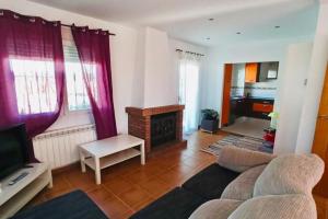 a living room with a couch and a fireplace at Casa del Río in Móstoles