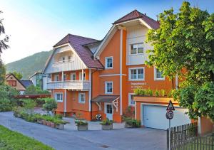 a large orange building with a garage in front of it at Dependance I in Schladming