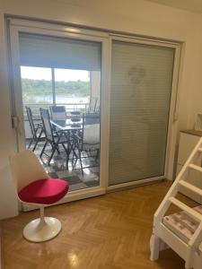 a room with a sliding glass door with a table and chairs at Apartment Thomy in Medulin