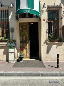 a front door of a building with a tumulus sign on it at Tom Square Boutique Hotel in Istanbul