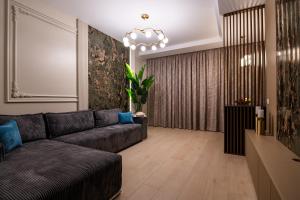 a living room with a couch and a chandelier at The 502 Mamaia in Mamaia