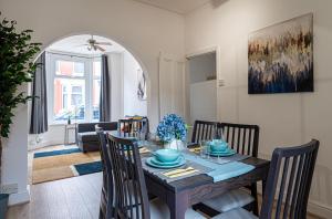 a dining room and living room with a table and chairs at Luxury Liverpool Accommodation in Liverpool