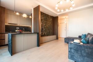 a living room with a couch and a kitchen at The 502 Mamaia in Mamaia