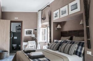 a bedroom with a large bed with striped pillows at Zia Letizia Bed And Wine in Monterosso al Mare +101 photos