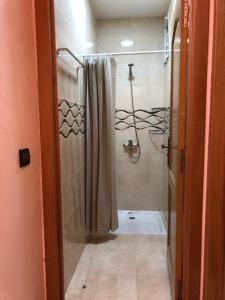 a bathroom with a shower with a shower curtain at Luxurious Holiday Home in Temara