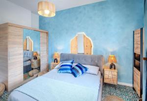 a bedroom with a large bed with blue walls at Dipinto di Blu by PortofinoVacanze in Rapallo