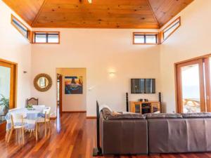 a living room with a couch and a table at King Tide House - Ocean Views in Burnt Pine