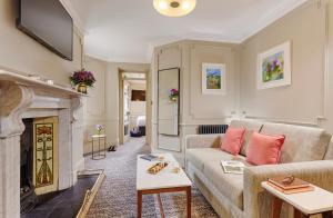 a living room with a couch and a fireplace at Waterloo Town House & Suites in Dublin