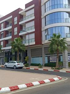 a car parked in front of a building at RESIDENCE SOUKHAINA AGADIR MAROC in Agadir