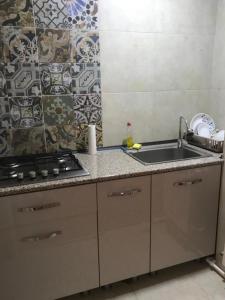 a kitchen with a sink and a stove at Telavi Tel Aviv in Tʼelavi