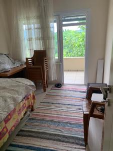 a bedroom with a bed and a large rug at Rize manzara evi 